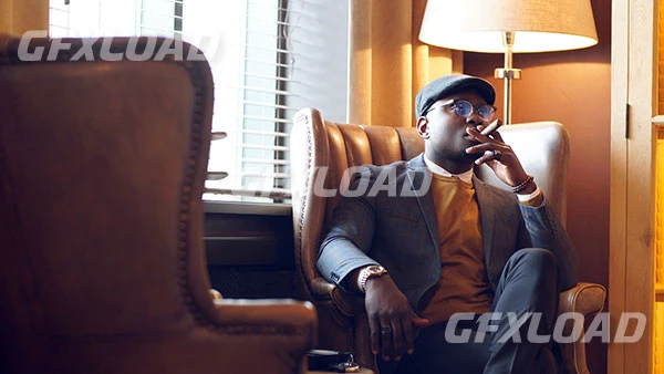 African American Man Stylish Jacket Smoking Cigar Sitting Restaurant Chair