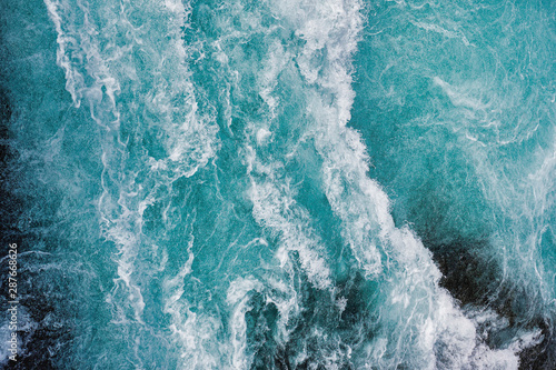 Free Download Bruarfoss waterfall in iceland as an abstract of the blue water and whitewater from above - GFXLoad
